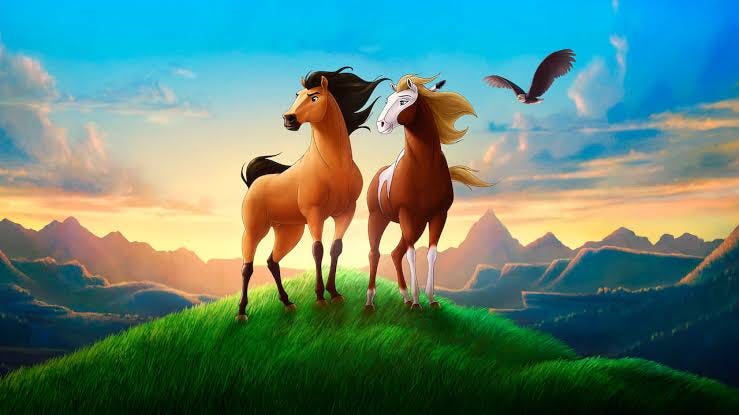 A Kiger mustang stallion and a Sorrel overo paint mare stand atop a grassy hill. A mountainscape is seen behind them, while a bald eagle soars over them.