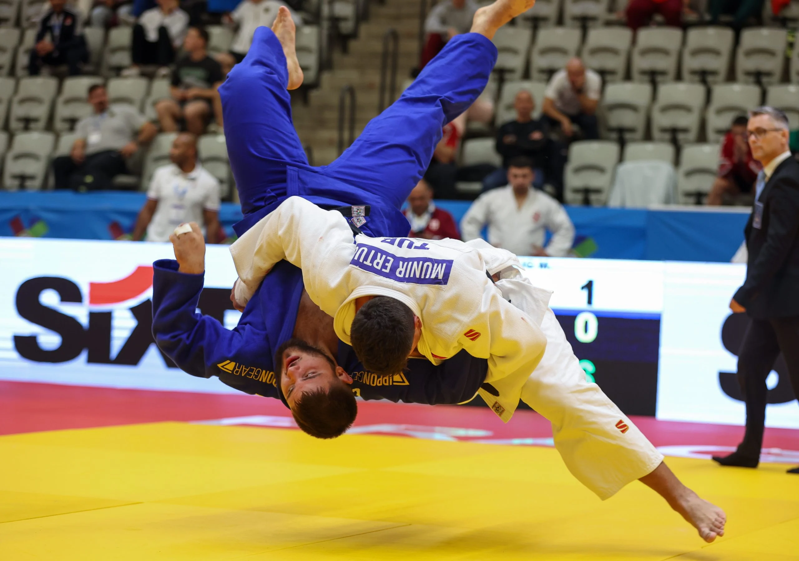 Both fighters are in the air due to the Turk's throw.