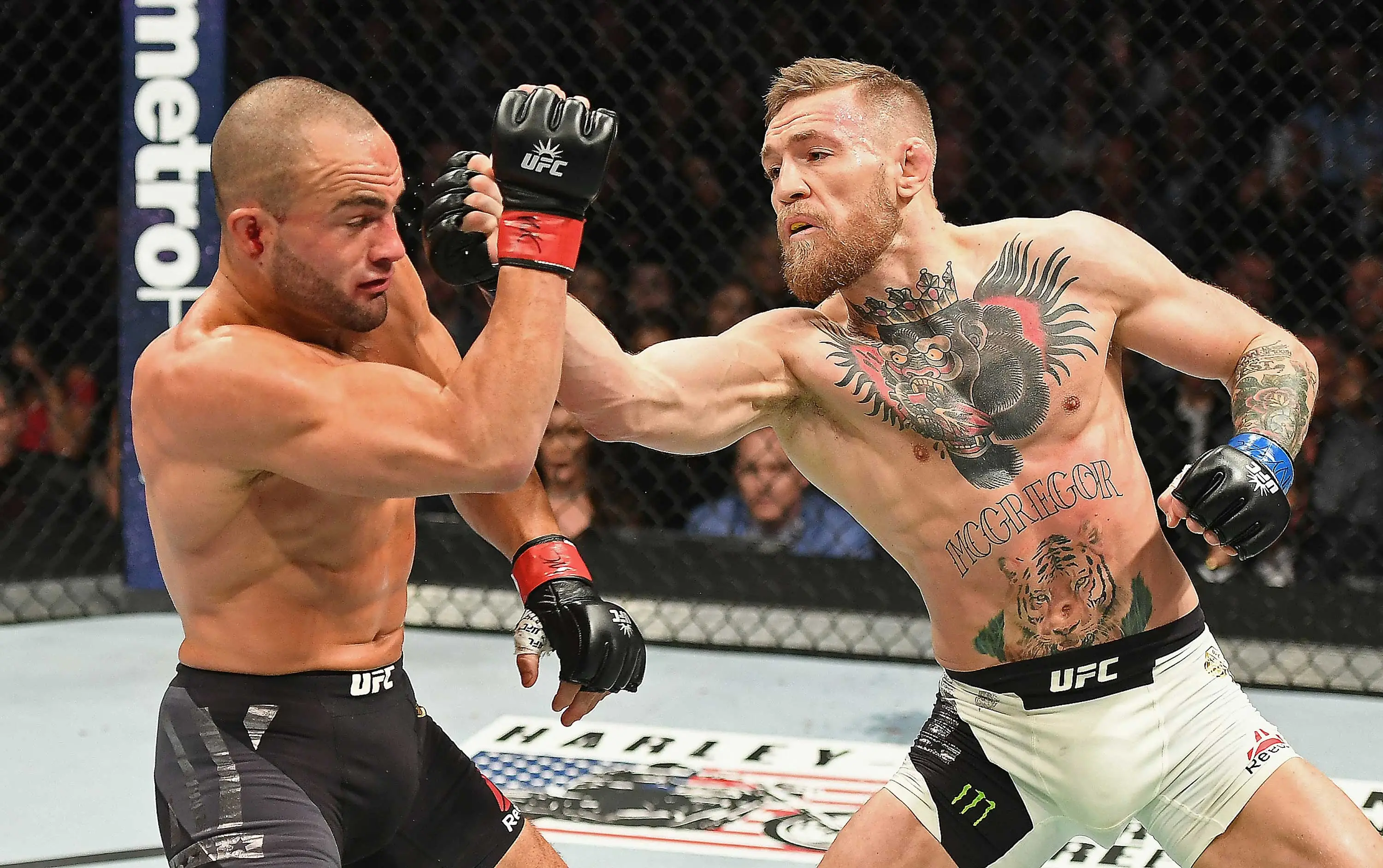 Conor McGregor prepares to strike his opponent in close combat.