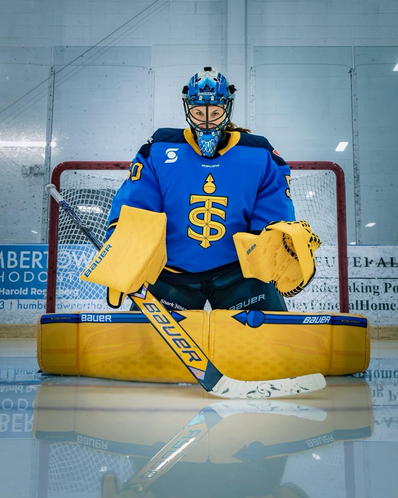 One of the golies wearing full gear i front of the goal.