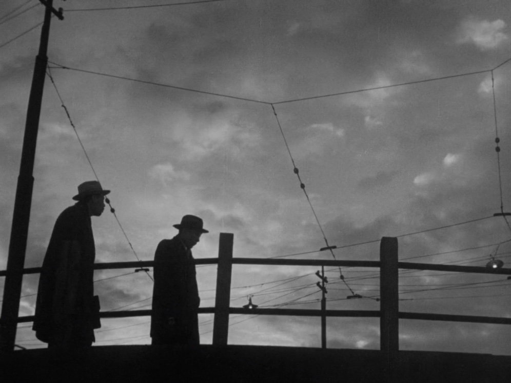 Scene from 'Ikiru', where two men are walking on a bridge