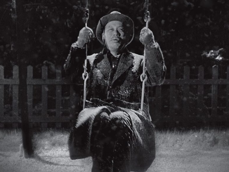 Scene from 'Ikiru', where an old man is on a swing