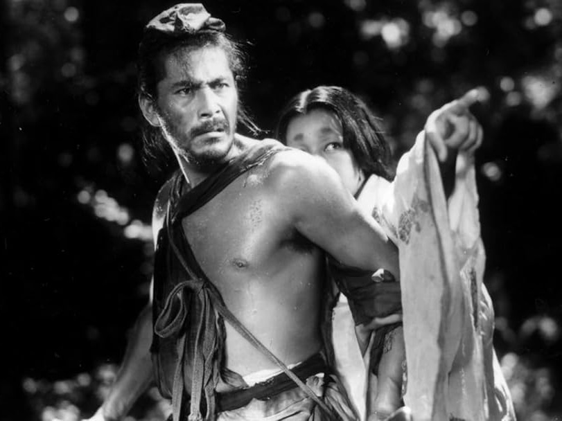 Scene from 'Rashomon', where a woman is pointing somewhere and hiding behind a man