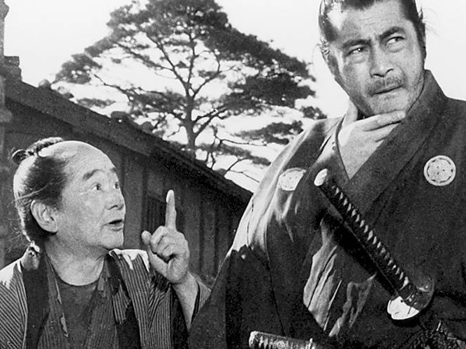 Scene from the movie 'Yojimbo', a man talking to a samurai who is thinking
