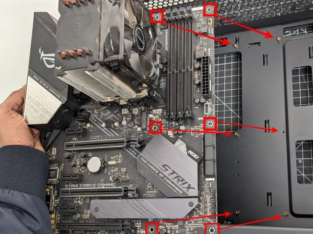 Installing a motherboard while showing the correct orientation in which the motherboard should be held