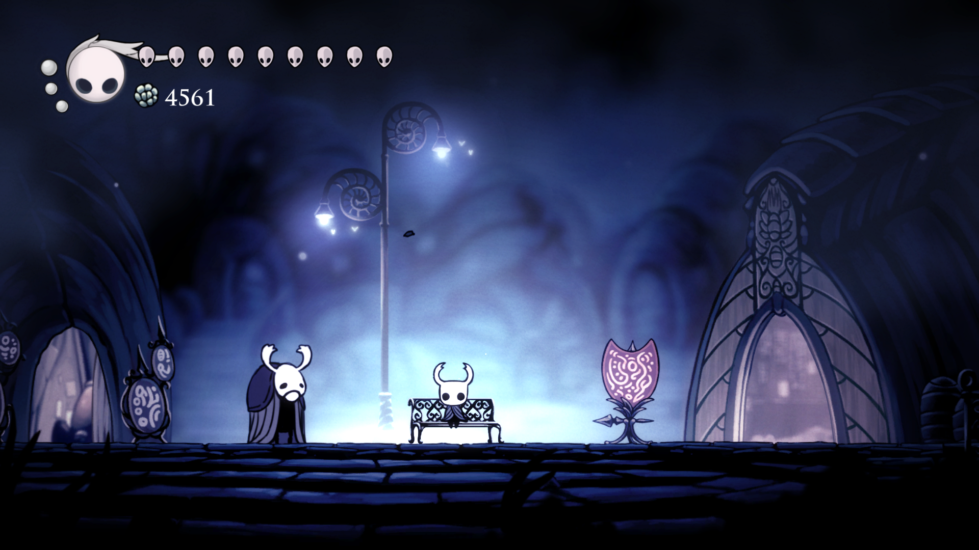 Hollow Knight játékból kép, a lovag pihen egy padnál